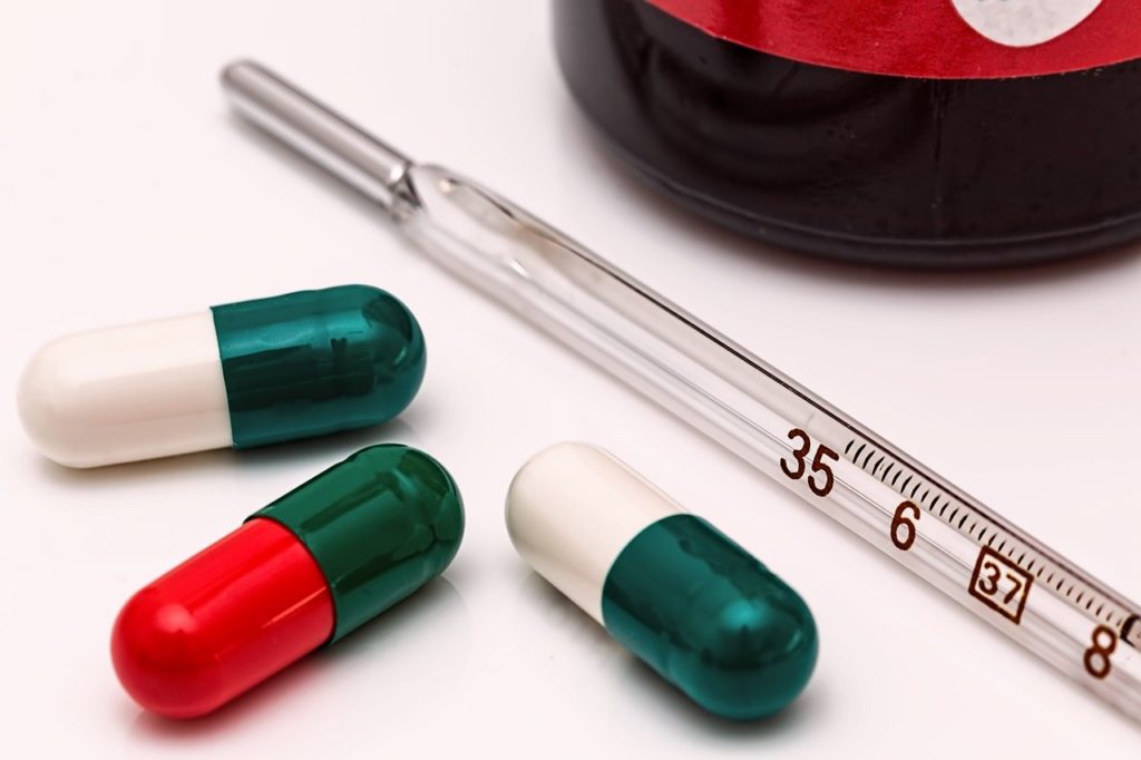 three pills and a thermometer